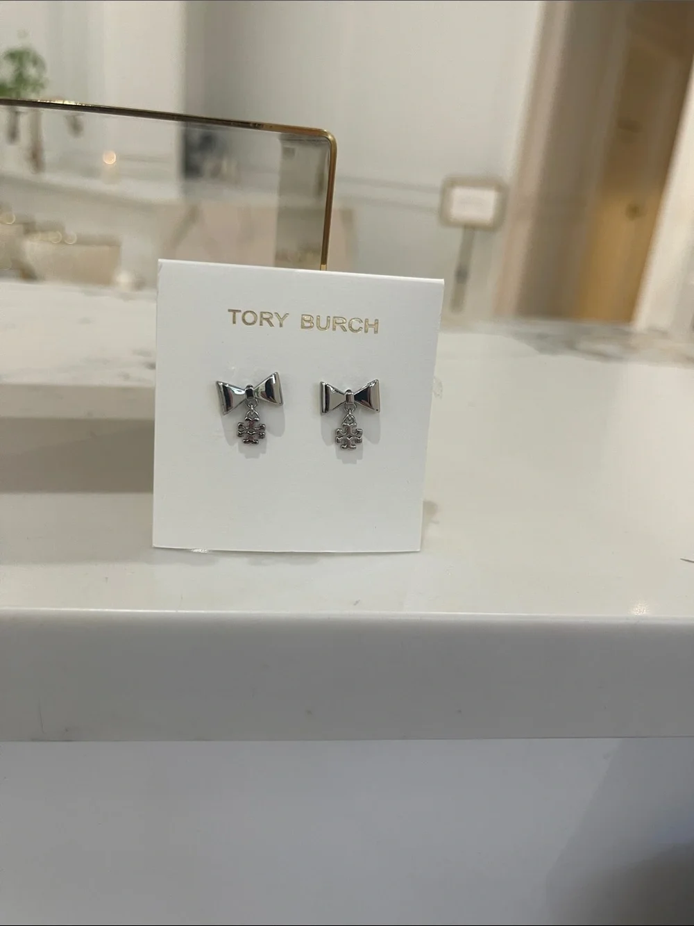 Tory Burch KPolished Silver Bow Earrings with Logo Charm